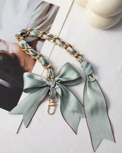 The elegant mobile hand chain feature a beautiful ribbon