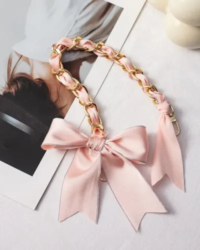 The elegant mobile hand chain feature a beautiful ribbon