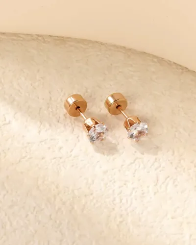 Trendy stud earring featuring stone and gold colour setting